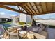 Relaxing covered patio with fire pit and comfortable seating at 7483 S Loback Ct, Queen Creek, AZ 85142