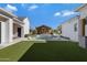 Inviting pool area with a pergola and lush landscaping at 7483 S Loback Ct, Queen Creek, AZ 85142