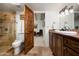 Bathroom with granite countertop, wood cabinets and a walk-in shower at 7500 E Mccormick Pkwy # 63, Scottsdale, AZ 85258