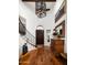 Grand entryway with hardwood floors, curved staircase, and ornate light fixture at 7500 E Mccormick Pkwy # 63, Scottsdale, AZ 85258