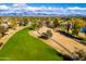 Aerial view of a lush golf course with lake and mountain backdrop at 7500 E Mccormick Pkwy # 63, Scottsdale, AZ 85258