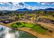 Aerial view of golf course with water feature and palm trees at 7500 E Mccormick Pkwy # 63, Scottsdale, AZ 85258