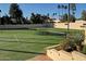 Well-maintained tennis courts with artificial turf and surrounding landscaping at 7500 E Mccormick Pkwy # 63, Scottsdale, AZ 85258