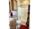 Bathroom with tub, toilet and wood cabinets at 7750 E Broadway Rd # 175, Mesa, AZ 85208