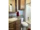 Bathroom with tub, toilet and wood cabinets at 7750 E Broadway Rd # 175, Mesa, AZ 85208