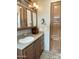 Bathroom with wood cabinets, a sink, and tiled floor at 7750 E Broadway Rd # 175, Mesa, AZ 85208