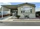 Attractive manufactured home with covered porch and landscaped yard at 7750 E Broadway Rd # 175, Mesa, AZ 85208