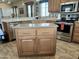 Large kitchen island with granite countertop and wooden cabinets at 7750 E Broadway Rd # 175, Mesa, AZ 85208