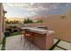 Outdoor kitchen and patio furniture under pergola at 7756 E San Miguel Ave, Scottsdale, AZ 85250