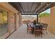 Covered patio with dining table and string lights at 7756 E San Miguel Ave, Scottsdale, AZ 85250