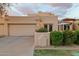 Tan stucco exterior with two-car garage and landscaped front yard at 7756 E San Miguel Ave, Scottsdale, AZ 85250