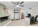 Home office with built-in desk and cabinet, fireplace, and large windows at 7756 E San Miguel Ave, Scottsdale, AZ 85250