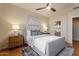 Main bedroom with plush carpet and ensuite bathroom at 8429 W Salter Dr, Peoria, AZ 85382