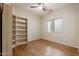 Spacious bedroom with built-in shelving and hardwood floors at 8429 W Salter Dr, Peoria, AZ 85382