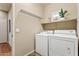 Convenient laundry room with washer, dryer, and shelving at 8429 W Salter Dr, Peoria, AZ 85382