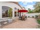 Relaxing patio with brick pavers, seating, and red umbrella at 8429 W Salter Dr, Peoria, AZ 85382