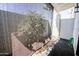 Private patio with a shaded seating area and flowering plants at 850 S River Dr # 1066, Tempe, AZ 85281