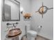 Stylish powder room featuring a unique vessel sink and modern fixtures at 8912 W Roberta Ln, Peoria, AZ 85383