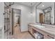 Contemporary bathroom with a sleek vanity, large mirror, and walk-in shower at 8912 W Roberta Ln, Peoria, AZ 85383