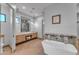 Bright bathroom with a freestanding tub, double vanity, and walk-in shower at 8912 W Roberta Ln, Peoria, AZ 85383