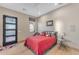 Cozy bedroom with red bedding and a modern door at 8912 W Roberta Ln, Peoria, AZ 85383