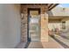 Modern front door with glass panels and stone surround at 8912 W Roberta Ln, Peoria, AZ 85383