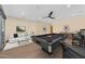 Spacious game room featuring a pool table, comfortable seating, and stylish decor at 8912 W Roberta Ln, Peoria, AZ 85383
