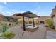 Hot tub with pergola cover and desert landscaping at 8912 W Roberta Ln, Peoria, AZ 85383