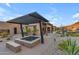 Hot tub with pergola cover and desert landscaping at 8912 W Roberta Ln, Peoria, AZ 85383