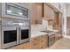 Modern kitchen with stainless steel appliances and light wood cabinets at 8912 W Roberta Ln, Peoria, AZ 85383