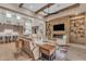 Open concept living room with kitchen views, a stone fireplace, and built-in shelving at 8912 W Roberta Ln, Peoria, AZ 85383