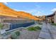 Modern rectangular pool with blue tile and desert landscaping at 8912 W Roberta Ln, Peoria, AZ 85383