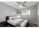 Well-lit bedroom featuring a queen bed and ceiling fan at 920 E 10Th Pl, Mesa, AZ 85203