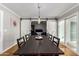 Bright dining room featuring a farmhouse table and sliding barn doors at 920 E 10Th Pl, Mesa, AZ 85203