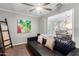 Cozy Gathering room with a black leather sofa and ceiling fan at 920 E 10Th Pl, Mesa, AZ 85203