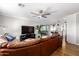 Spacious living room with a brown leather sectional sofa and hardwood floors at 920 E 10Th Pl, Mesa, AZ 85203