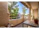 Private balcony with table and chairs, offering a treetop view at 9305 E Purdue Ave # 265, Scottsdale, AZ 85258