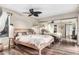 Main bedroom with a wooden bed frame, mirrored closet doors, and dark wood floors at 9305 E Purdue Ave # 265, Scottsdale, AZ 85258