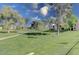 Expansive green lawn with mature trees and walkways at 9305 E Purdue Ave # 265, Scottsdale, AZ 85258