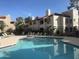 Community swimming pool with surrounding lounge chairs at 9305 E Purdue Ave # 265, Scottsdale, AZ 85258