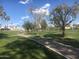 Scenic walking path winding through a lush green landscape at 9305 E Purdue Ave # 265, Scottsdale, AZ 85258