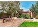 Landscaped backyard oasis with pergola, pond, and stone pathway at 9543 E Palomino Pl, Sun Lakes, AZ 85248