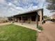 Home exterior showcasing a covered patio and grassy yard at 9543 E Palomino Pl, Sun Lakes, AZ 85248