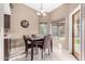 Bright dining area with a table and four chairs near the back door at 9543 E Palomino Pl, Sun Lakes, AZ 85248