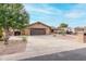 House exterior with a brown garage door and driveway at 9543 E Palomino Pl, Sun Lakes, AZ 85248