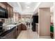 Modern kitchen with dark cabinetry, stainless steel appliances, and tile flooring at 9543 E Palomino Pl, Sun Lakes, AZ 85248