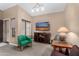 Cozy living room with green accent chair and TV at 9543 E Palomino Pl, Sun Lakes, AZ 85248