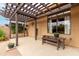 Charming pergola covered patio with bench and potted plants at 9543 E Palomino Pl, Sun Lakes, AZ 85248