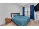 Bedroom with teal bedding and wood nightstand at 9832 E Wavelength Ave, Mesa, AZ 85212