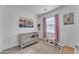 Bedroom with crib, toy kitchen and pink curtains at 9832 E Wavelength Ave, Mesa, AZ 85212